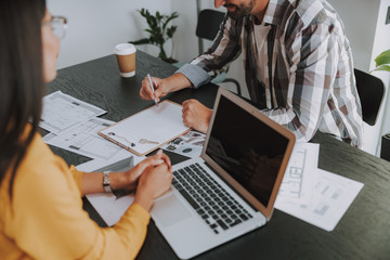 Young man is looking on agreement in office
