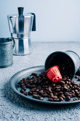 Organic coffee capsule with coffee beans on colorful background. Color contrast. copy space