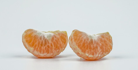 Two slices peeled segment Chinese mandarin or tangerine isolated on white background