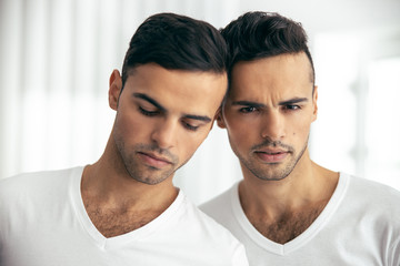 Two guys resting heads against each other