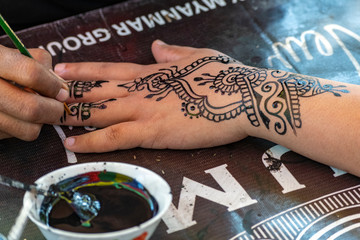 Fototapeta na wymiar Traditional henna hand painting at Maha Sandar Mahi Pagoda