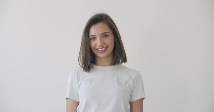 Young woman open eyes on white background