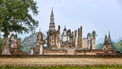 Fototapeta na wymiar Ruins of Ancient Thai Temples. Famous Sukhothai Historical Park, a UNESCO World Heritage Site. The ancient capital of Sukhothai, Thailand