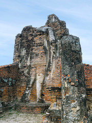 Fototapeta premium Buddha statues of Ancient Thai Temple (Wat Phra pai Luang). Famous Sukhothai Historical Park, a UNESCO World Heritage Site. The ancient capital of Sukhothai, Thailand