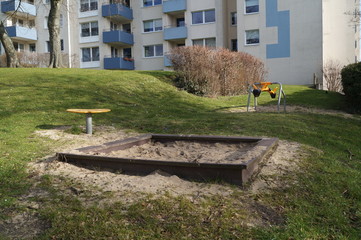 Wooden sandpit in the garden with toys. The world of children.