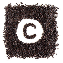 Letter C made out of aromatic coffee beans, top view, isolated on white background. Letter from word Coffee.