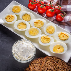 boiled chicken eggs on a dark stone background