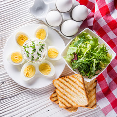 boiled chicken eggs on a white wooden rustic background