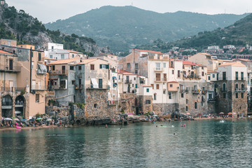 Fototapeta premium Cefalù, Sicily, Italy - August 22, 2019. The old buildings on the sea of Cefalù, an old fishing Sicilian village
