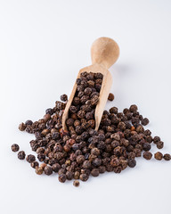 fragrant black pepper on white acrylic background
