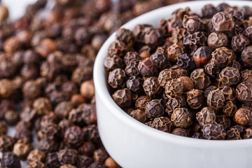 fragrant black pepper on white acrylic background