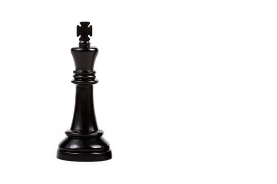 Black king chess game piece alone isolated on white background. King, royalty, ruler symbol, game piece representation, strategic thinking, intelligence, competition and power symbol abstract