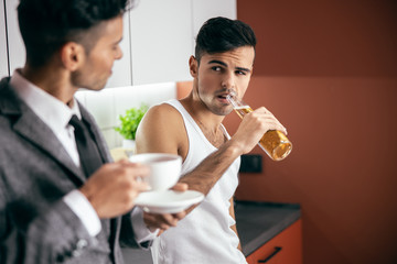 Two brothers looking each other in the kitchen