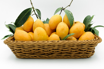 A basket of Fresh Marian plums on white background.