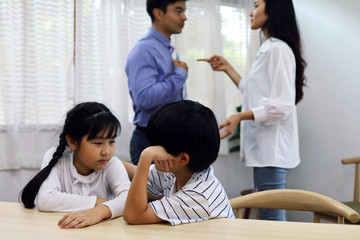 Family problems concept, father and mother quarreling in the house so causing children to feel bad.