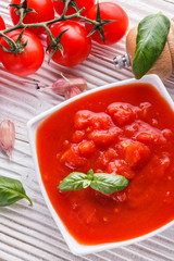 juicy canned tomatoes on wooden rustic background