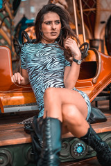 Fototapeta na wymiar Street style, portrait of a young brunette on a carousel