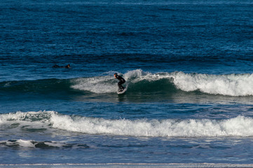 Sport surfing on the beach of zurriola located in san sebastian spain