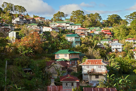 Scenic view on traditionally built houses with rusty metal roofs and metal sheets protecting the walls, seen in the town center of Sagada, Philippines