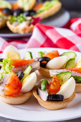 delicious snack tartlets on dark stone background