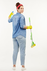 Pretty woman using several cleaning objects at the camera.