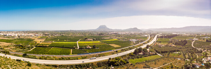 Aerial view of the AP7 highway in the cities of Ondara and Denia, Spain. Montgo mountain is in the background.