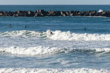 Sport surfing on the beach of zurriola located in san sebastian spain