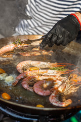 chef cooks shrimp at street food festival