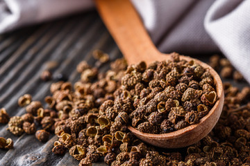 Sichuan pepper on a dark wooden rustic background