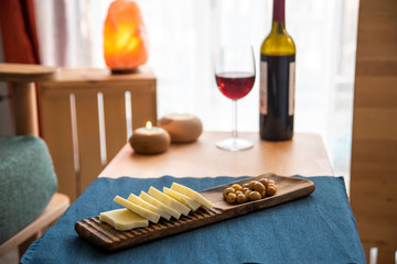 red wine and cheese plate on the table 