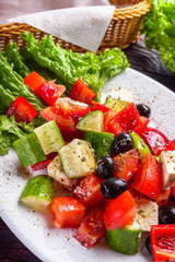 greek salad on dark wooden rustic background