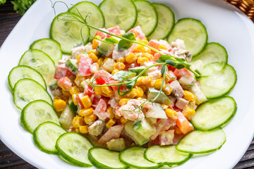Fresh salad of vegetables and meat on wooden rustic background