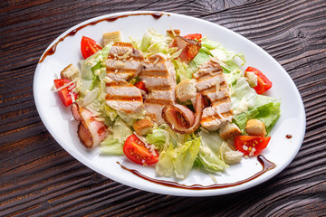 Caesar salad on dark wooden rustic background