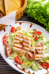 Caesar salad on dark wooden rustic background