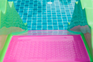 Swimming pool with slider in hotel pool resort.  Water slider in swimming pool. slider into the swimming pool out door.