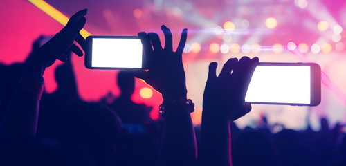 social media concept crowd people hand hold smartphone capture exitied moment in colorful lighting...