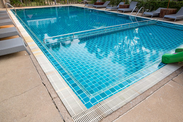 Swimming Pool.swimming pool bottom caustics ripple and flow with waves background.Swimming pool of luxury hotel.