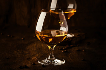 Armagnac, French grape brandy, strong alcoholic drink. Still life in vintage style with cigar smoke, copy space, toned