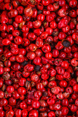 fragrant pink peppercorns on white acrylic background