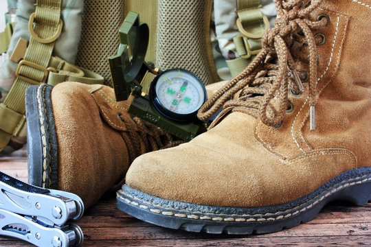 Old touristic shoes and compass