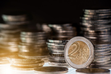 Stack of coins on black background, revenue or income money for invest and saving concept