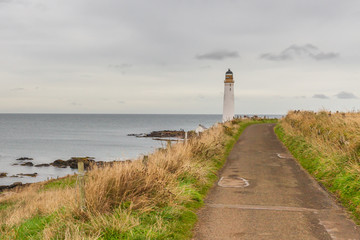 Fototapeta na wymiar MONTROSE, SCOTLAND - 2015 OCTOBER 25. Walking path to Scurdie Ness Lighthouse.