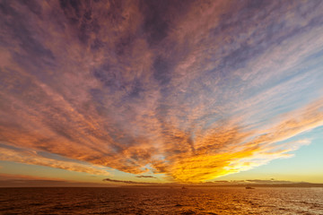 Fototapeta na wymiar Sunset at sea with colorful clouds.