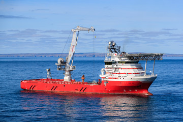 WICK, SCOTLAND - 2017 MARCH 23. Offshore crane vessel Siem N Sea with the crane high above the deck.