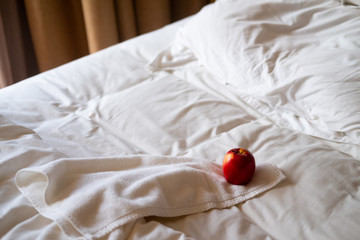 Red apple a on white bed in the morning