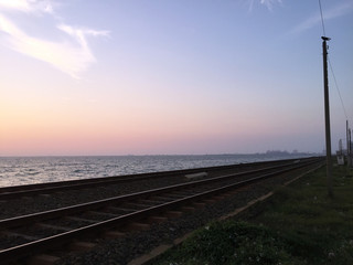 Fototapeta na wymiar Colombo, Sri Lanka - 20th March 2018 : Oceanview along with the railroad at sunset