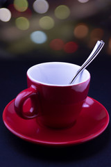 coffee red cup and coffee beans on bokeh background