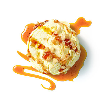 Vanilla ice cream ball with caramel syrup and wallnuts isolated on white background