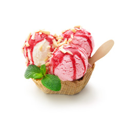 Various colorful ice cream balls with raspberry sauce, almonds and mint leaf in waffle basket