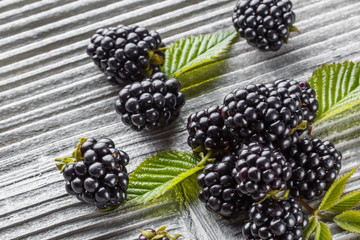 juicy blackberries on gray wooden rustic background